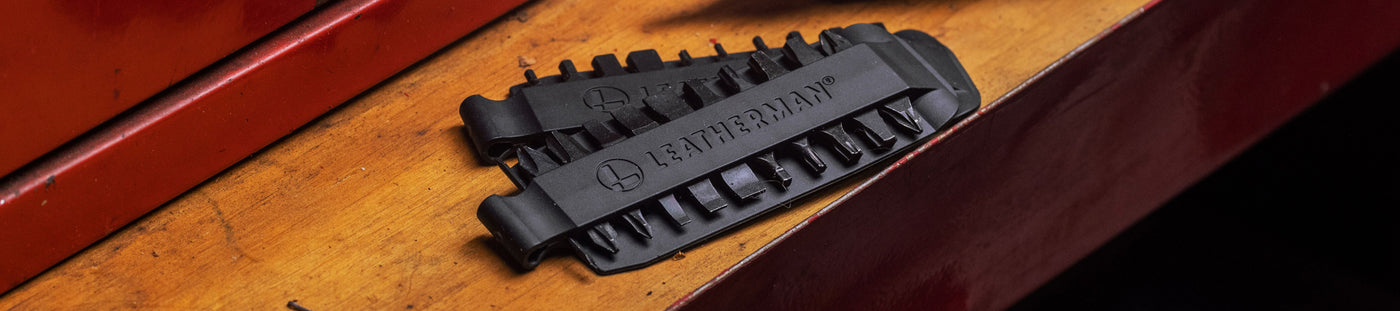 Translation missing: de.Close-up of a Leatherman Bit Kit set on a wooden surface, showcasing the detailed design and functionality