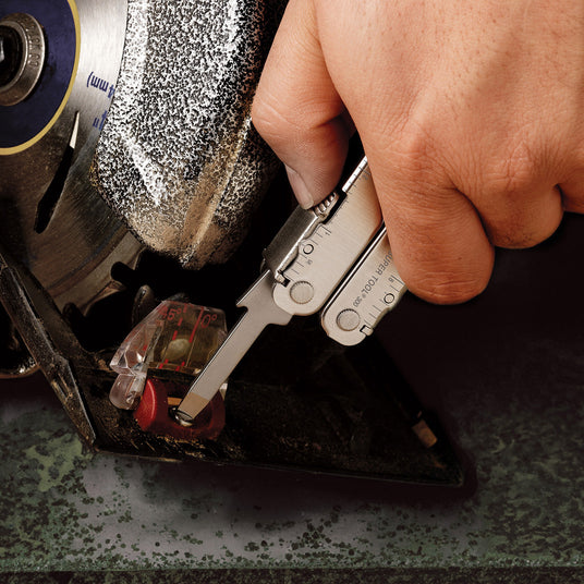 Translation missing: en.Someone using the medium screwdriver on a Leatherman Super Tool 300 to tighten something