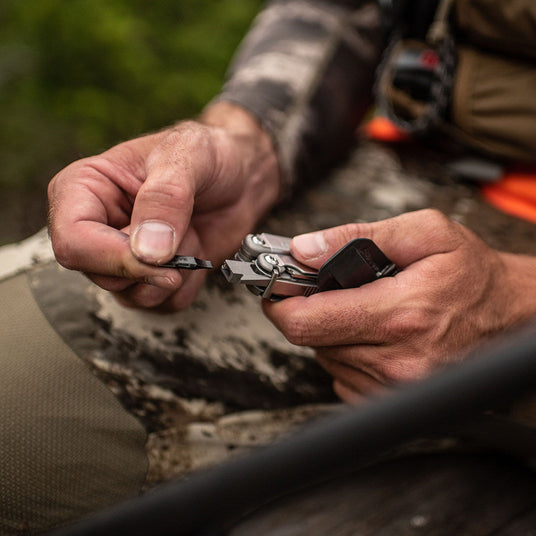 A man replacing a bit on a Leatherman Wave.