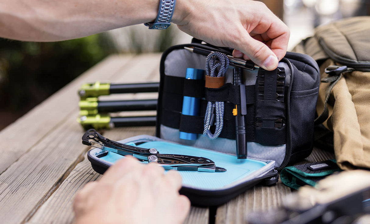 Translation missing: fr.Man pulling bit kit from Leatherman® Adapt Kit