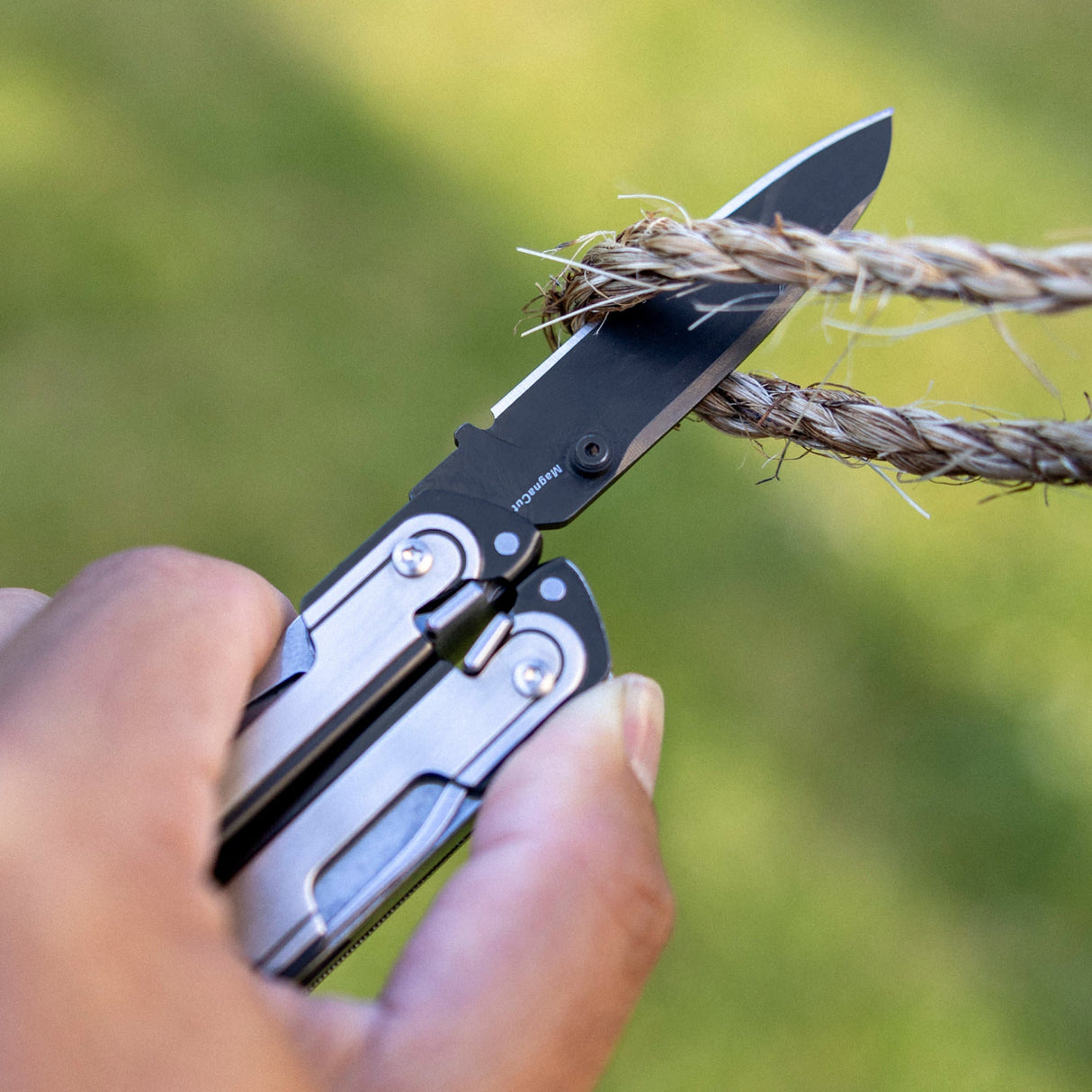 Translation missing: es.Person using one hand to open a Black DLC and stainless steel Leatherman ARC® multitool