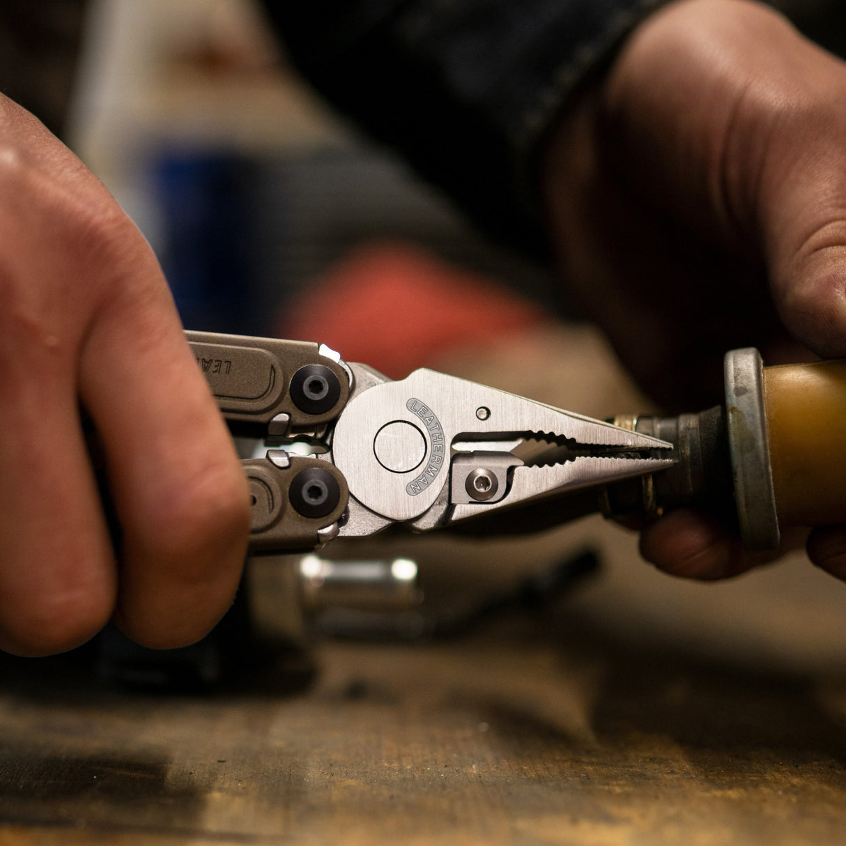 Translation missing: en.Close-up of hands using Leatherman ARC® Talos multi-tool pliers