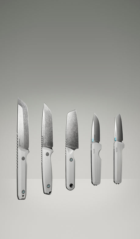 Translation missing: pl.Product display image featuring five Leatherman knives in a clean, gradient-lit studio setting. The lineup includes various blade styles and handle orientations, all in a matching alpine white colorway, showcasing both profile and edge-on views to highlight the craftsmanship and design variations