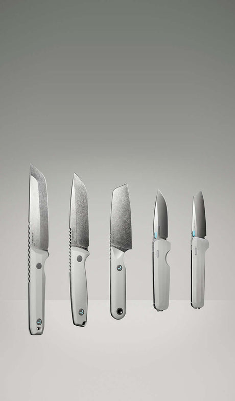 Translation missing: nl.Product display image featuring five Leatherman knives in a clean, gradient-lit studio setting. The lineup includes various blade styles and handle orientations, all in a matching alpine white colorway, showcasing both profile and edge-on views to highlight the craftsmanship and design variations