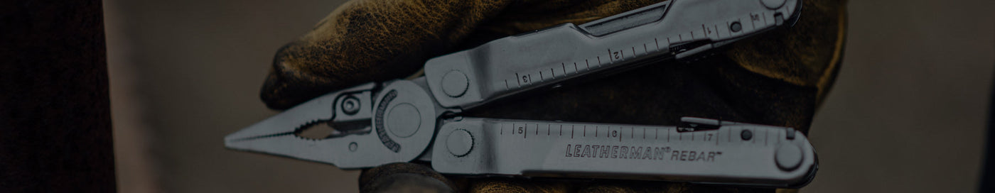 Translation missing: en.Gloved hand holding a leatherman Rebar with the pliers out