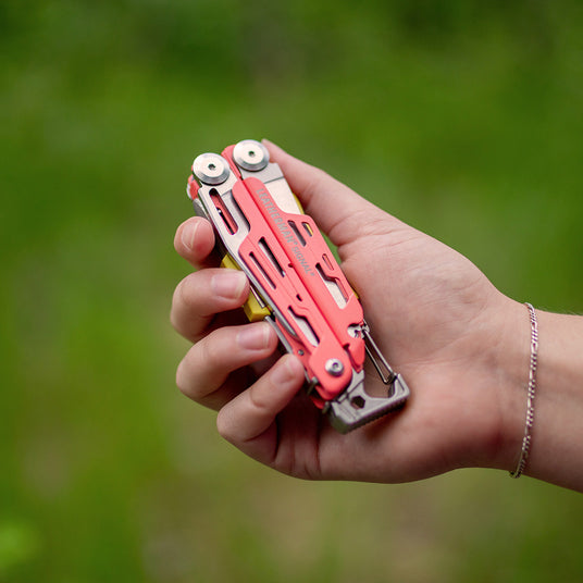 A hand holding a Leatherman Signal, highlighting its practical features and portability.