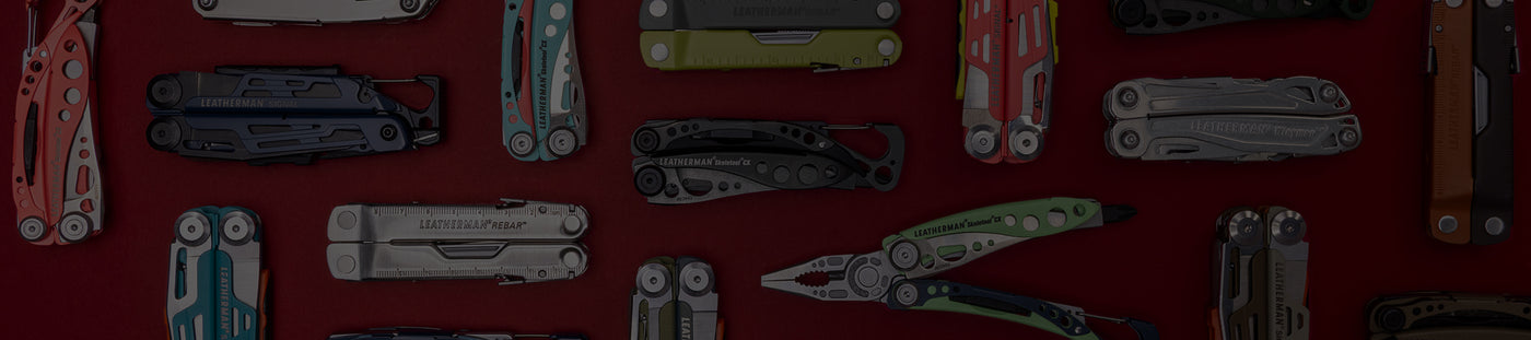 Translation missing: de.A variety of Leatherman tools in different styles are arranged on a vibrant red surface