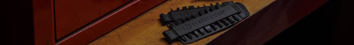Translation missing: pl.Close-up of a Leatherman Bit Kit set on a wooden surface, showcasing the detailed design and functionality