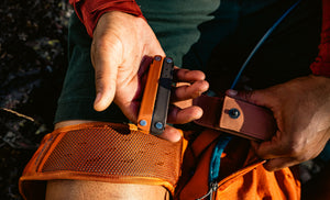 Person holding a closed Burnt Sienna bond in one hand and an open Sienna sheath in the other hand.