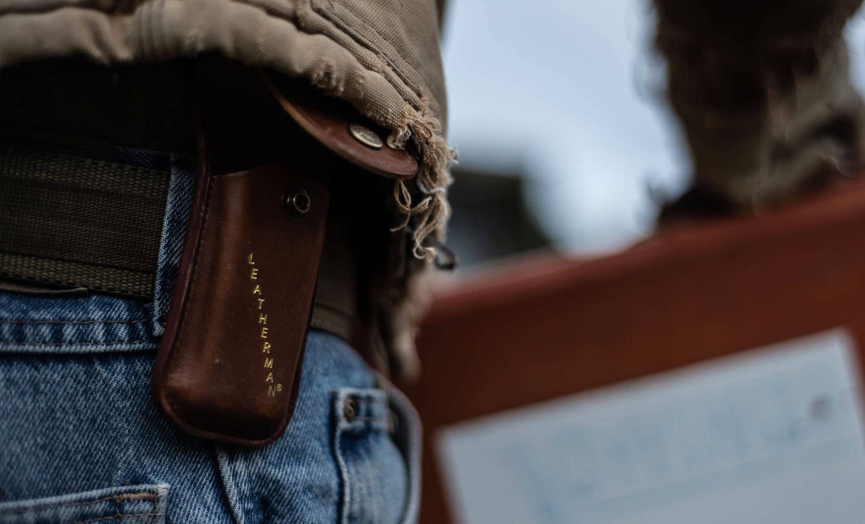 Man with brown jacket wearing Leatherman Heritage Sheath on belt