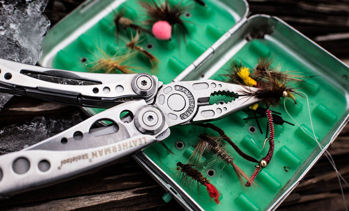 Skeletool pliers holding a fishing hook