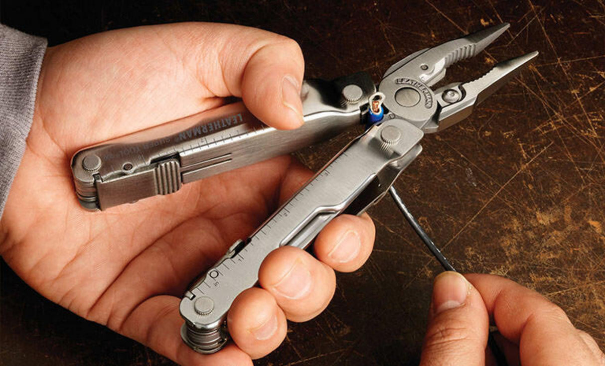 Man using Leatherman Super Tool 300 to strip wire 