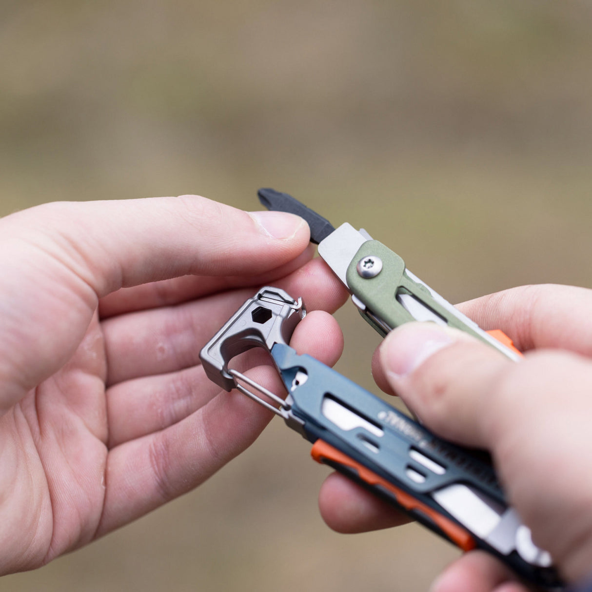 A person holding Leatherman Signal in their hand, showcasing bit driver and bit.