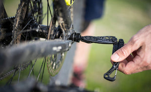 skeletool tightening a bike tire axle