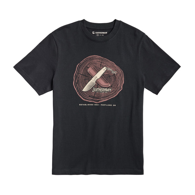 Translation missing: es.Front of the black Leatherman Blade &amp; Grain tee  showcasing a fix blade knife and leather sheath on a stump