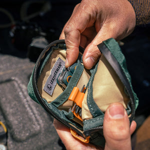 Translation missing: de.A person holds Leatherman Hunter Tool Pouch, showcasing its compact size and practical design