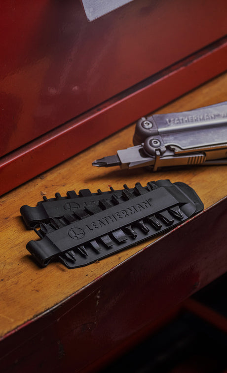 Translation missing: fr.
Leatherman Bit Kit Set laying on a wooden surface alongside a Leatherman Stainless Steel multi-tool with a bit attached
