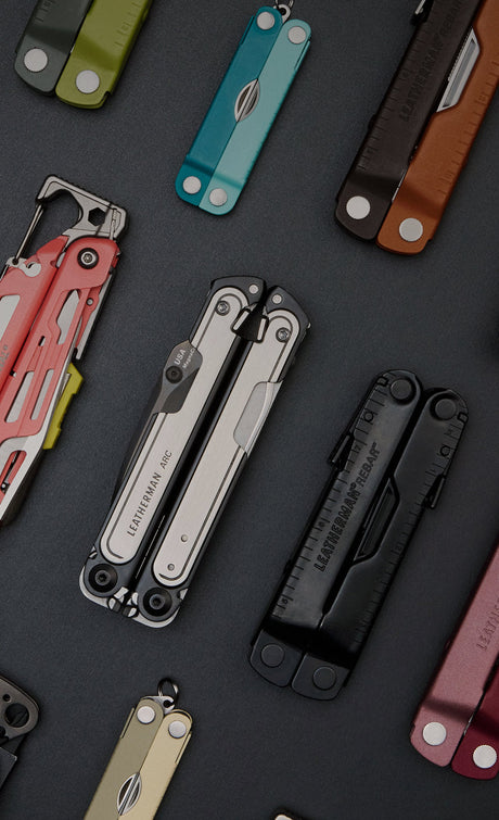 An array of Leatherman tools closed laying on a black background.