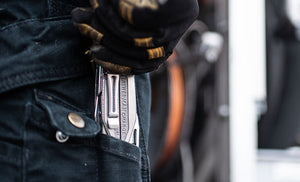 Translation missing: en.Man with dirty black and yellow gloves pulling Charge+ TTI out of back jean pocket
