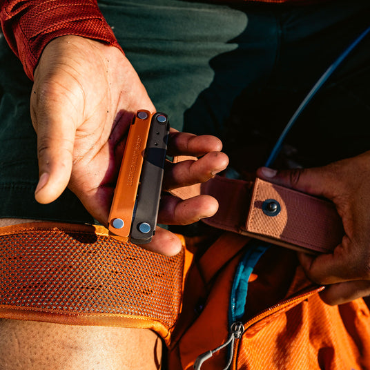 A hand firmly holds Leatherman Bond highlighting its size and design.