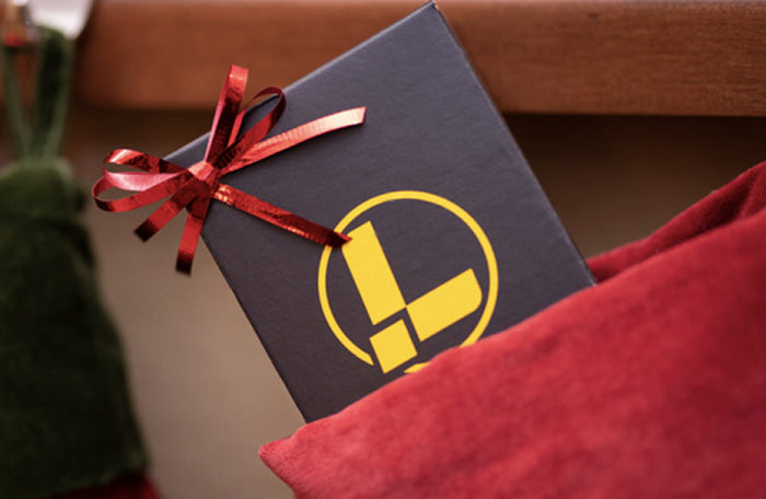 Translation missing: nl.A festive Christmas stocking filled with a Leatherman gift box wrapped in bright red ribbon, ready for holiday celebrations