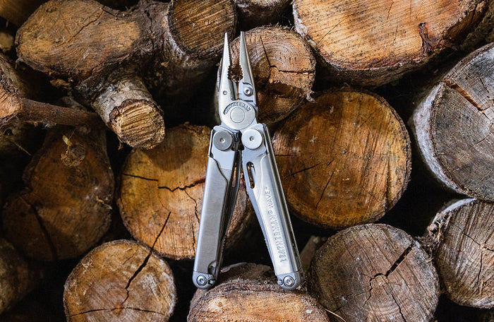 Translation missing: nl.Leatherman Wave+ resting on a wooden surface, showcasing their metallic finish against the natural wood grain