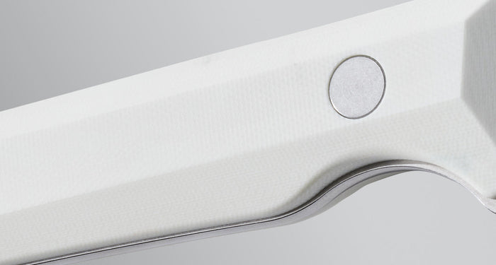 Close-up view of the white textured handle of a Leatherman knife, showcasing the clean lines, contoured grip, and precision-fastened hardware against a neutral background.